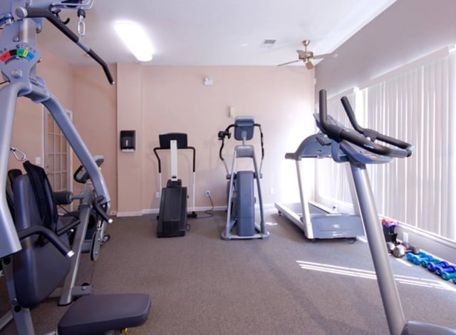 Fitness center with treadmills, elliptical, and weight machine.
