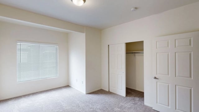Bedroom with a closet and a window