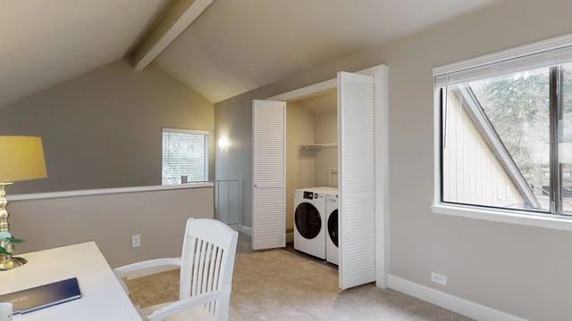 Washer and dryer in a closet with bi-fold doors.