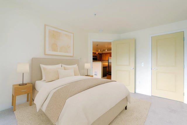 Bedroom with a king-sized bed and two nightstands.