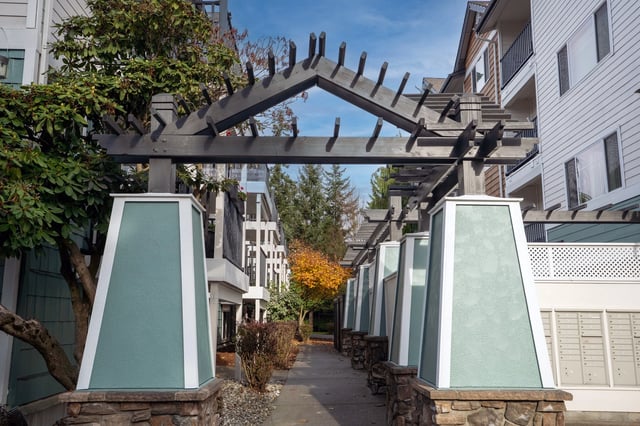 Walkway with pergolas leading to apartment buildings