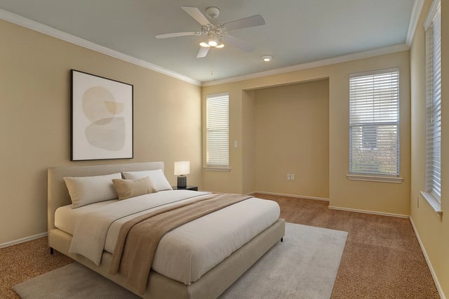 Modern bedroom with king-size bed, ceiling fan, and large windows.