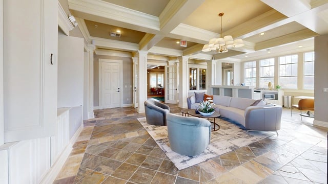 Community lounge with modern furniture and large windows.