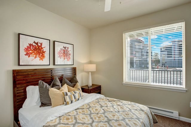 Bedroom with queen bed and artwork