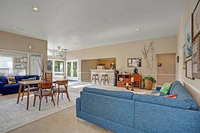 Community lounge area with seating, a small dining table, and a wet bar.