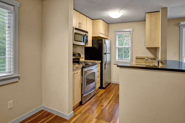 Kitchen with stainless steel appliances and wood cabinets.