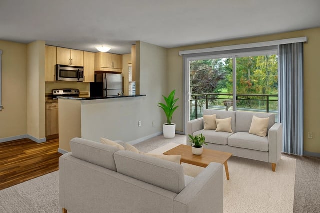Living room and kitchen area with modern furniture and a balcony view.