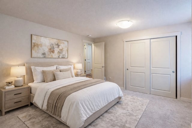 Cozy bedroom with a queen-size bed, nightstands, and a large closet.