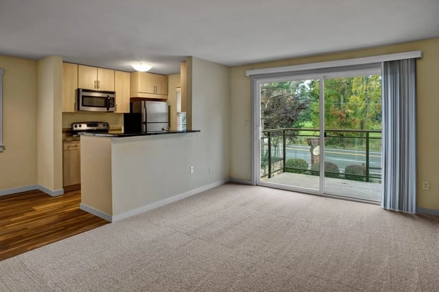 Open concept living area with kitchen and balcony access