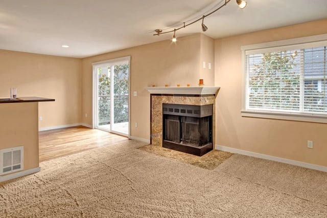 Living room with a fireplace and sliding glass doors.