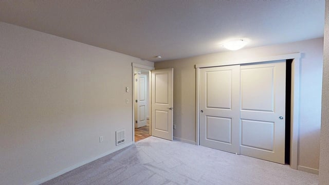 Bedroom with closet and doors to other rooms