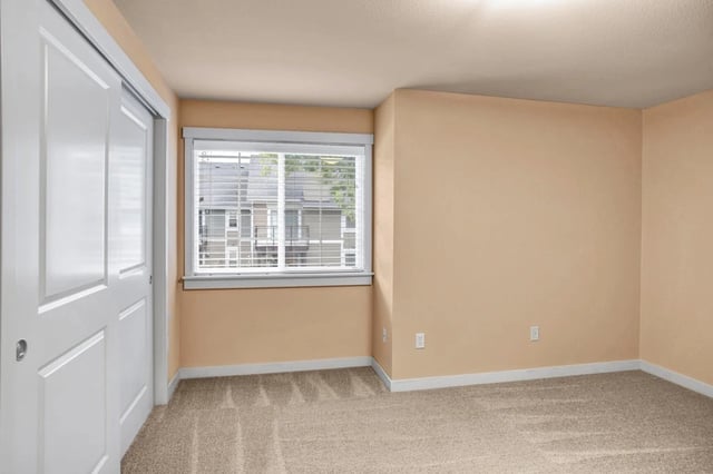 Bedroom with closet and window.