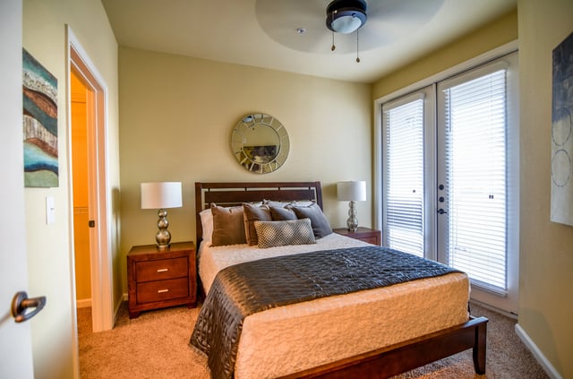 Bedroom with king-size bed, nightstands, and closet access.