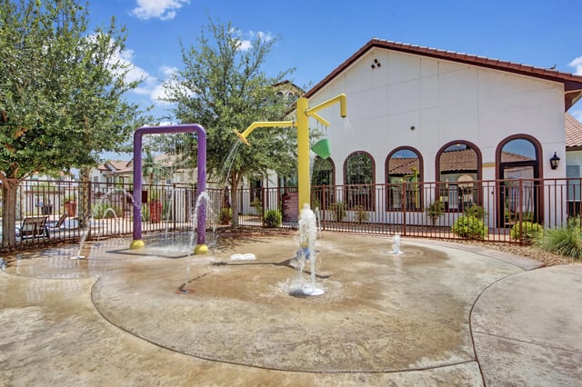Splash pad with water features and playground equipment.
