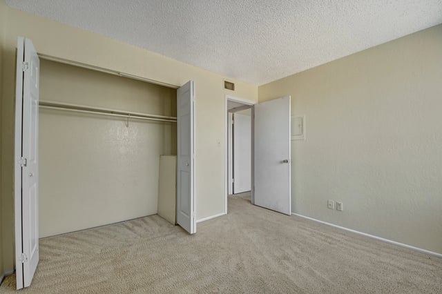 Empty bedroom with closet and doorway