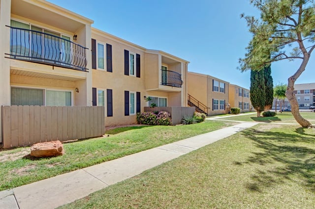 Exterior view of apartment buildings with balconies and walkways.