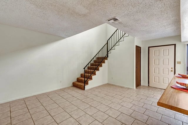 Living area with stairs and front door
