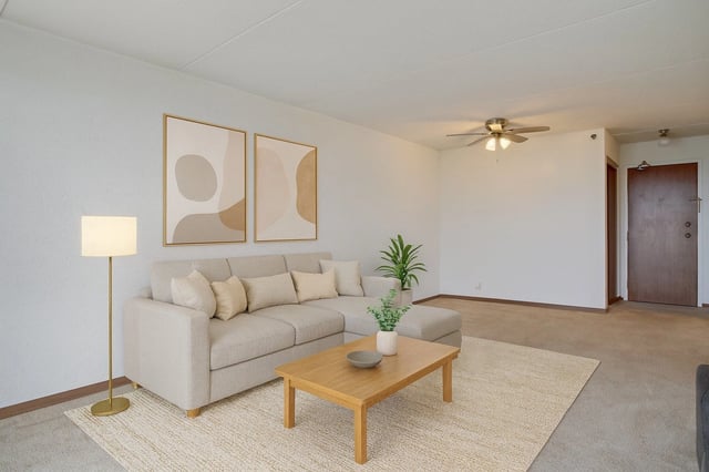 Spacious living room with a sectional sofa, coffee table, and abstract art.