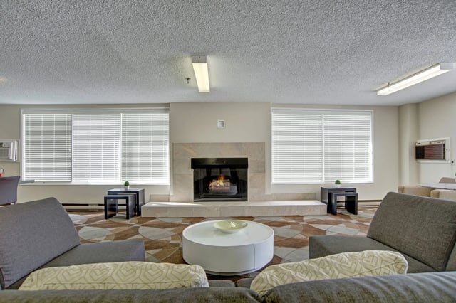 Clubhouse lounge area with fireplace and seating.