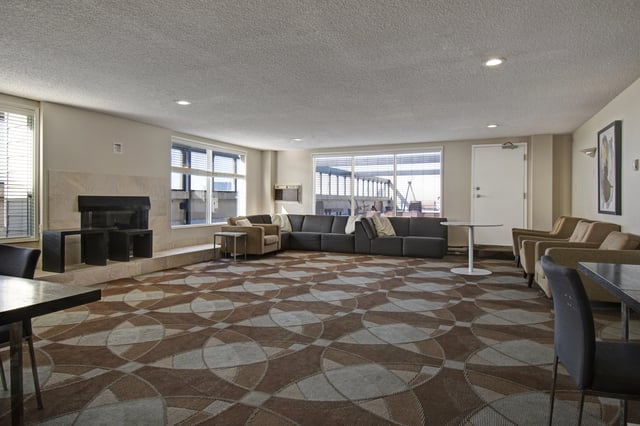 Community lounge with fireplace and seating area