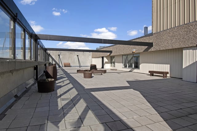 Rooftop patio with seating and planters