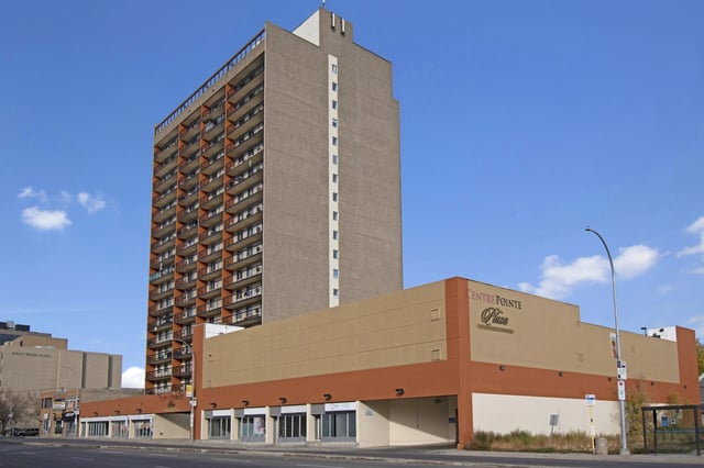 Centre Pointe Plaza apartment building exterior with balconies and signage.