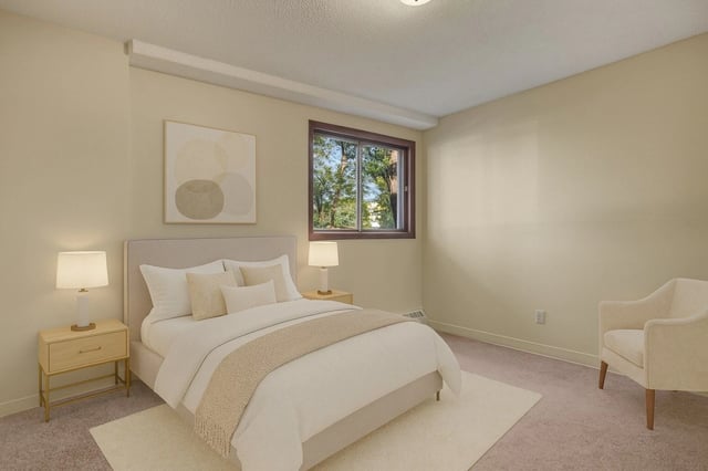 Cozy bedroom with a queen-size bed, nightstands, and a comfortable armchair.