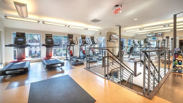 Fitness center with treadmills, ellipticals, and weight equipment.