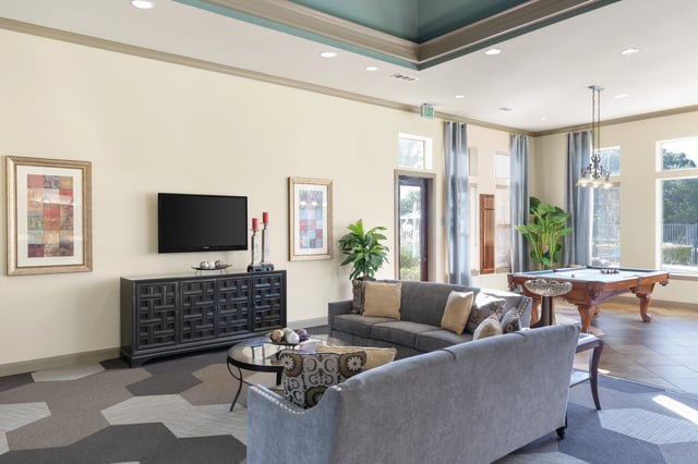 Comfortable seating area with a pool table and a television.