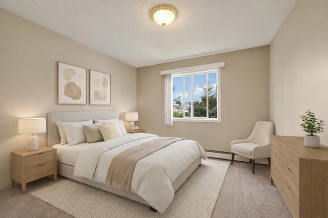 Bedroom with a king-size bed, nightstands, dresser, and a chair next to the window.