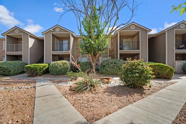 Apartment building exterior with pathways and landscaping.