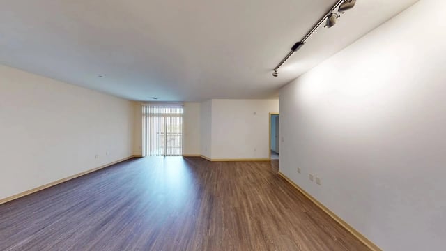 Spacious living room with hardwood floors and a sliding glass door.