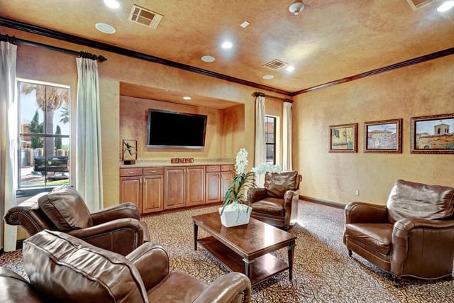 Lobby lounge area with plush leather armchairs and a coffee table.