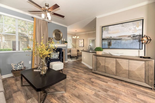 Living room with fireplace, dining area, and kitchen counter
