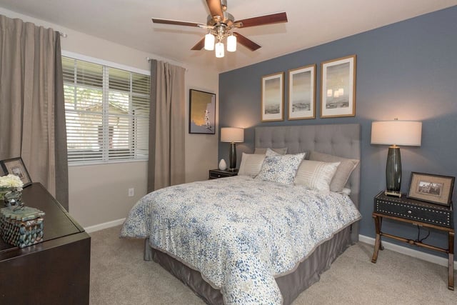 Bedroom with a queen-size bed, nightstands, and a dresser.