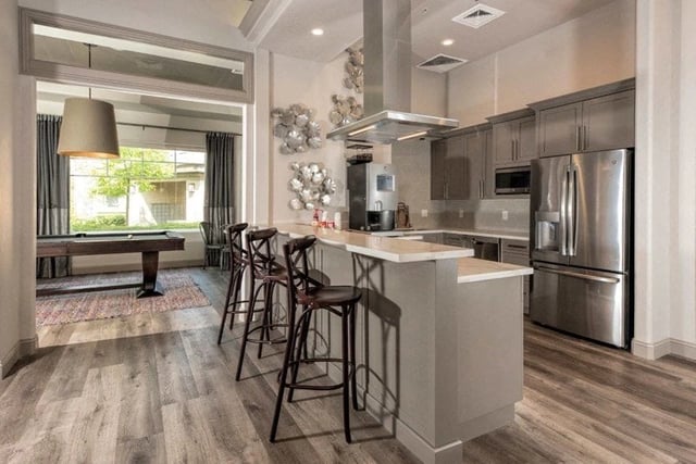 Kitchen with a billiard table visible in the background.