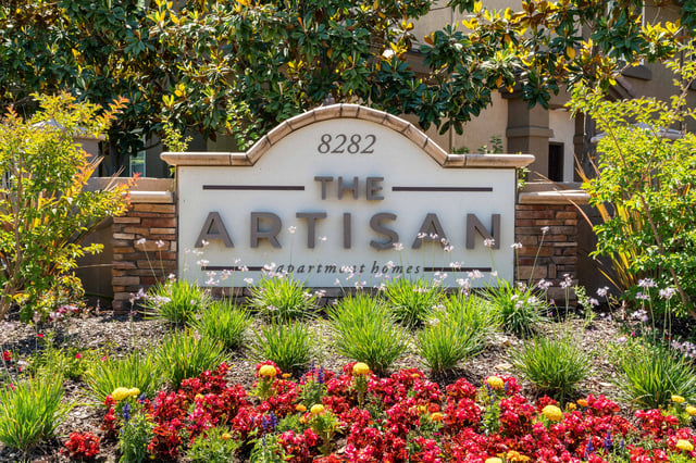 The Artisan apartment homes monument sign with landscaping.