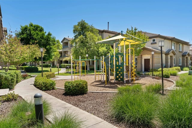 Playground with jungle gym and slide in a residential community.