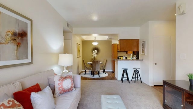 Living room, dining area, and kitchen of an apartment.