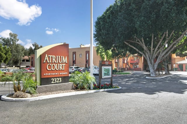 Atrium Court Apartment Homes monument sign with address 2323 and property map.