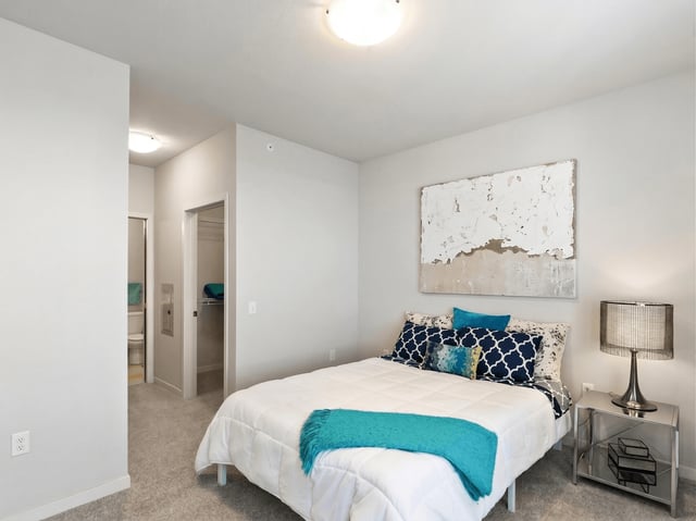 Bedroom with a bed, nightstand, and closet.