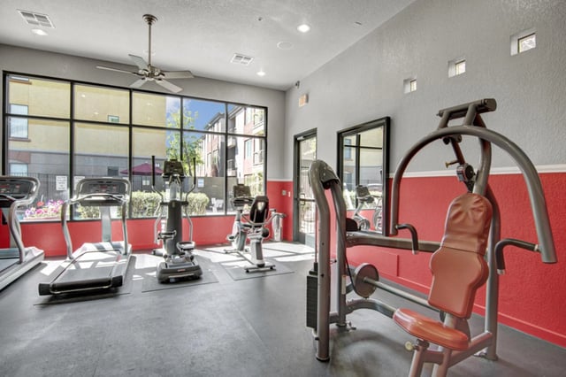 Fitness center with treadmills, ellipticals, and weight machines.