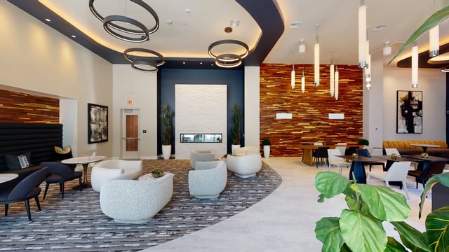 Modern lounge area with a fireplace and seating.