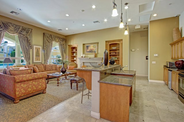 Elegant communal lounge area with comfortable seating and a kitchen island.