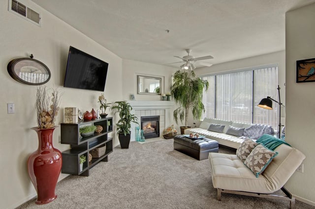 Spacious living room with a fireplace, TV, and comfortable seating.