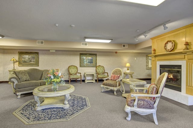 Lobby with fireplace, seating area, and decorative elements.