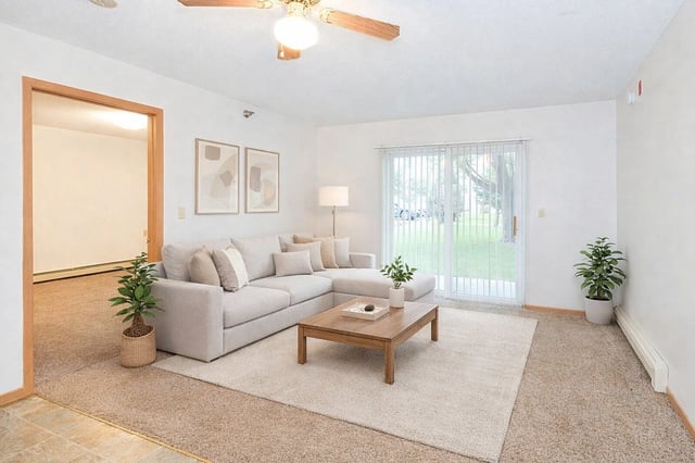 Living room with sectional sofa, coffee table, and artwork.
