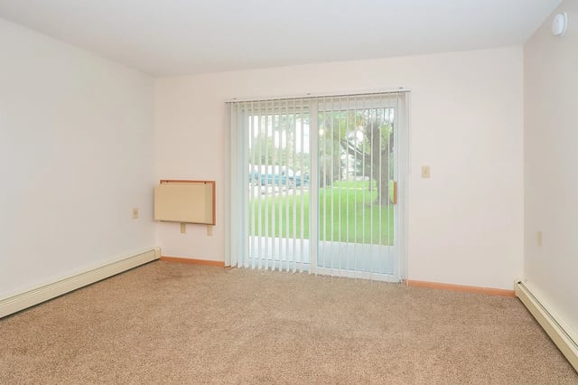Living room with sliding glass door and carpet