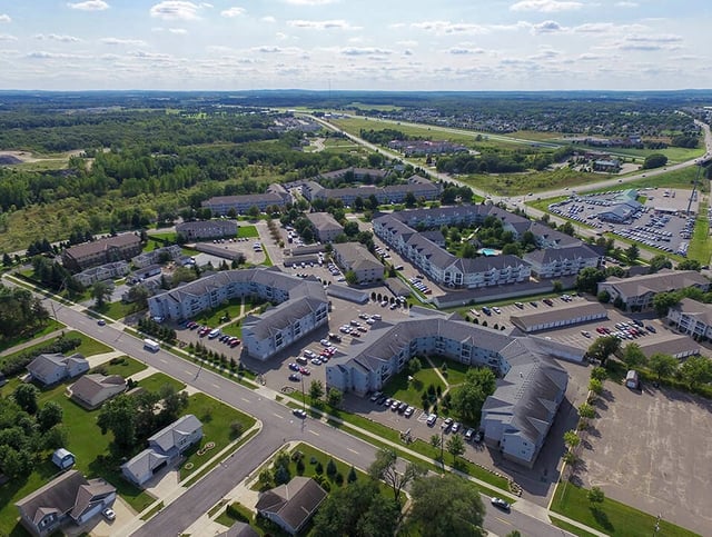 Aerial view of apartment buildings and surrounding neighborhood.