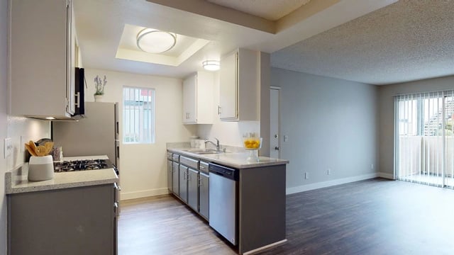 Modern kitchen with stainless steel appliances and granite countertops.